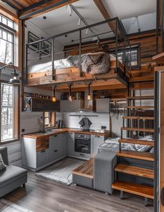 the loft bed is built into the wall above the kitchen and living room, with stairs leading up to the upper level