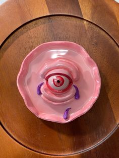 an odd looking object on top of a wooden table in the shape of a bowl