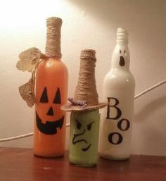 three halloween bottles are sitting on a table