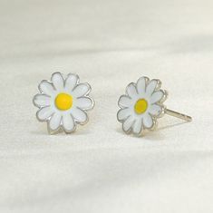 "This stunning 925 sterling silver daisy flower push back stud earrings and necklace set is the perfect gift for any woman who loves sunflowers, nature, or simply beautiful jewelry. The set is made with high-quality sterling silver and features delicate sunflower designs. The earrings feature a single sunflower design with a push back closure. The necklace features a pendant with a larger sunflower design on a delicate chain. The sunflowers are both adorned with sparkling cubic zirconia stones, Mother's Day Sterling Silver Birth Flower Earrings, Sterling Silver Daisy Jewelry, Sunflower Design Jewelry For Mother's Day, White Flower Jewelry With Sunflower Design, White Flower-shaped Jewelry With Sunflower Design, Mother's Day Sterling Silver Flower Earrings, White Sunflower Design Flower Jewelry, Silver Daisy Jewelry Gift, Silver Daisy Jewelry For Gift