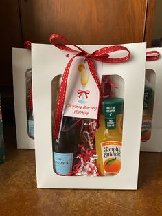 two bottles of orange juice in a gift bag