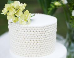 a white cake with yellow flowers on top