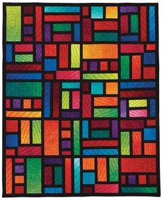 a multicolored quilt with squares and lines on it's sides, all in different colors