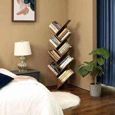 a room with a bed, lamp and bookshelf