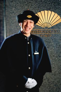 a man in uniform standing next to a wall