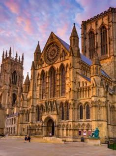 an old cathedral is lit up at sunset