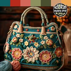 a handbag with flowers on it next to some yarn and a ball of thread