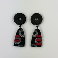 pair of black and red earrings on white background