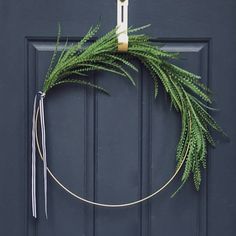 a green wreath hanging on the front door