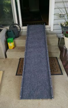 a blue rug sitting on the side of a house