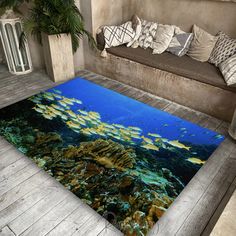 a large area rug with fish swimming in the water and on top of it is a couch