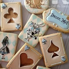 some cookies are decorated with different designs on them, and the cookie is shaped like playing cards