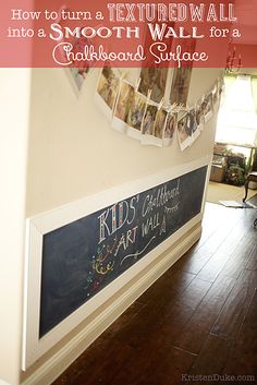 there is a chalkboard on the wall with pictures hanging above it and text overlay that reads how to turn a textured wall into a smooth wall for a cardboard surface