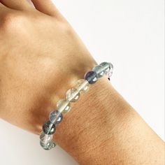 a woman's arm with a bracelet made out of glass beads