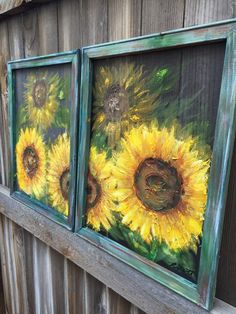 three sunflowers painted on old window frames