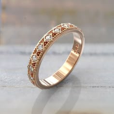 a gold ring with small diamonds on it