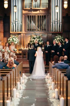 a bride and groom walking down the aisle at their wedding ceremony in front of an organ