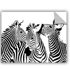 three zebras are standing together in front of a black and white wall art piece