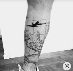 a black and white photo of a man's leg with a plane on it