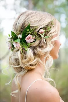 a woman with flowers in her hair wearing a flower headpiece on her wedding day