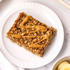 a white plate topped with granola bars and peanut butter drizzled on top