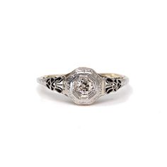 an antique style diamond ring with filigrees