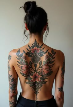 the back of a woman with tattoos on her body