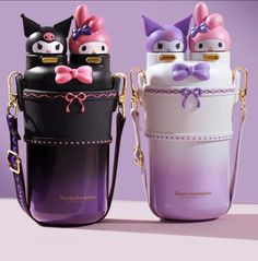 two purses with cats on them are sitting next to each other in different colors