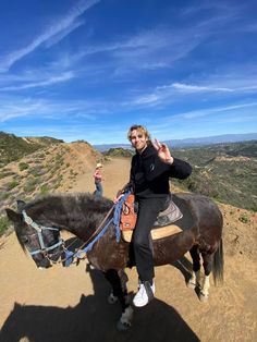 a man riding on the back of a brown horse