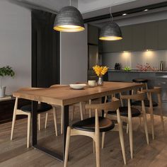 a dining room table with four chairs and a bowl of flowers on the table in front of it