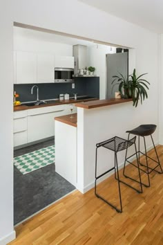 two stools are in front of the kitchen counter