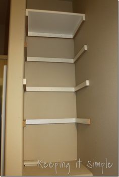 an empty closet with shelving in it