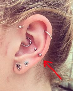 an ear with four piercings attached to it, and the word double hex piercing on