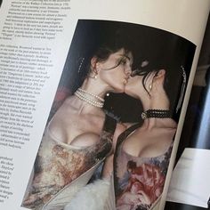 an open magazine with two women kissing each other