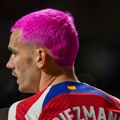 a man with pink hair wearing a jersey