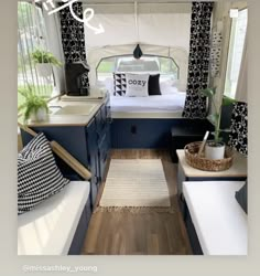 the interior of a camper with blue and white decor