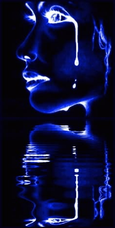 a woman's face is reflected in the water