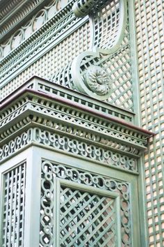 an ornate metal door on the side of a building