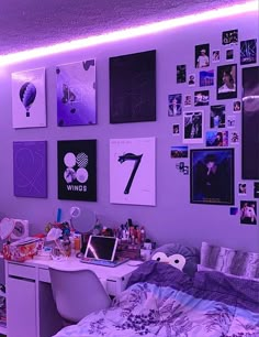 a bedroom with purple lighting and pictures on the wall