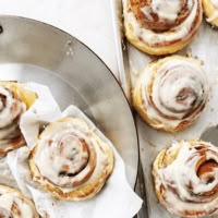 a pan filled with cinnamon rolls on top of a table