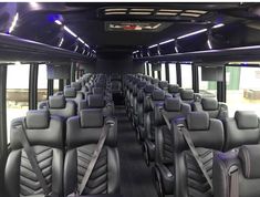 the inside of a bus with many seats and lights on it's ceiling is shown