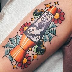 a colorful tattoo on the leg of a person with a purple tube and spider web