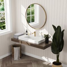 a bathroom sink sitting under a mirror next to a potted plant and a window