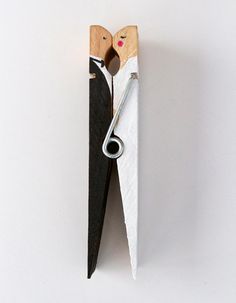 a pair of scissors are attached to a piece of wood