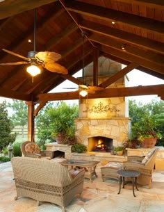 an outdoor living area with furniture and a fireplace