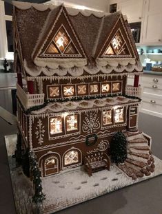 a large gingerbread house with lights on it