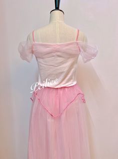 a pink dress on a mannequin headdress