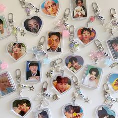 several key chains with pictures of people on them and stars hanging off the sides of them