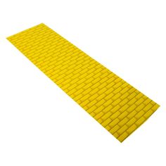 a yellow brick floor mat on a white background