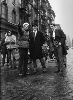 black and white photograph of people standing in the street